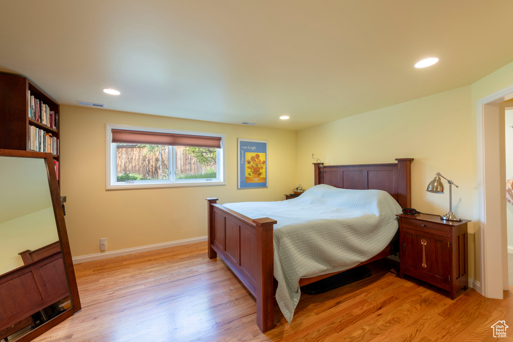 Bedroom featuring light wood-style floors, baseboards, and recessed lighting