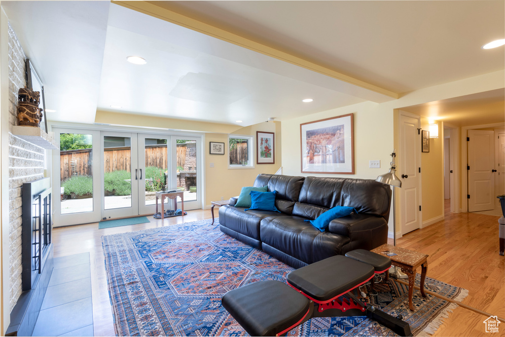 Living area with french doors, recessed lighting, and light wood-type flooring