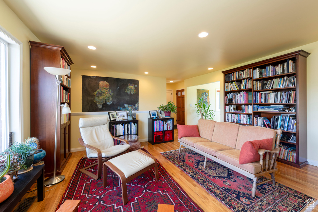 Living room with wood finished floors, recessed lighting, and baseboards
