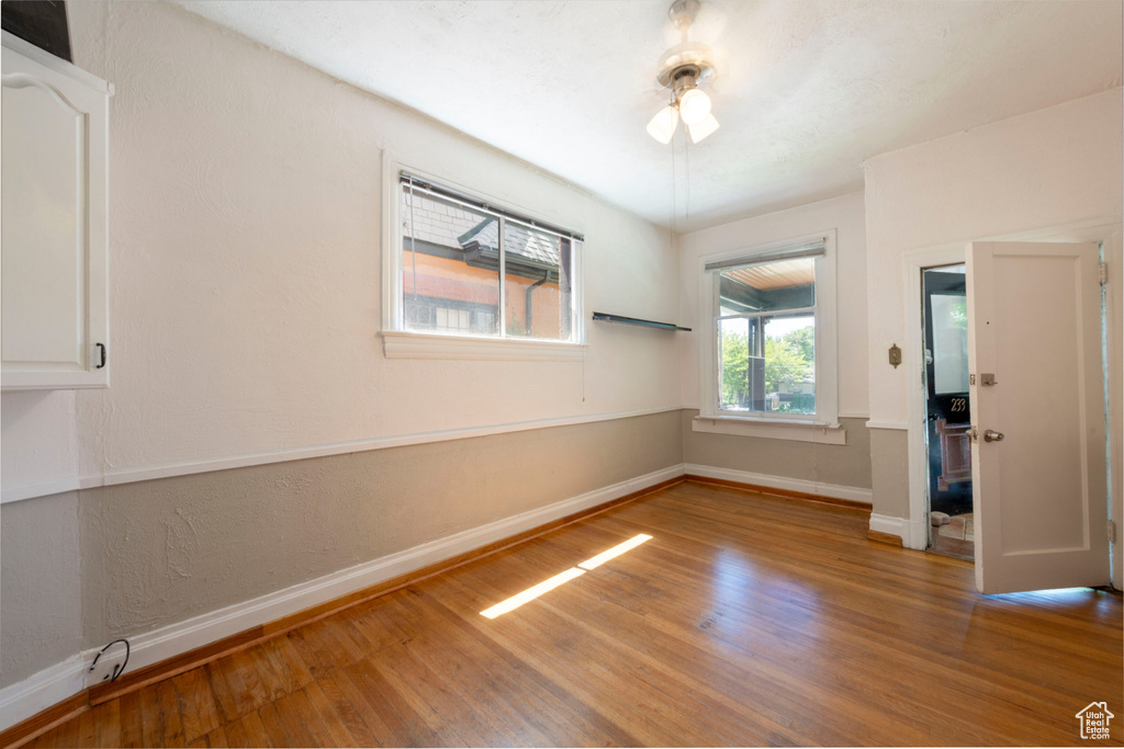 Unfurnished room with wood finished floors and baseboards