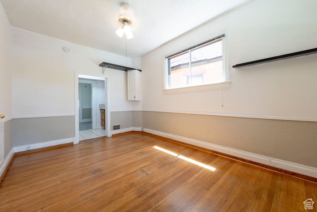 Empty room with light wood finished floors and baseboards