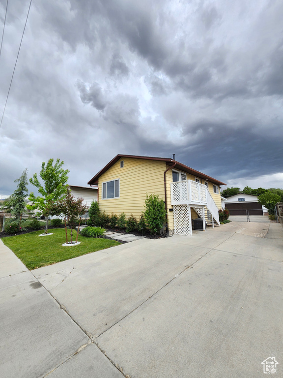 View of home\'s exterior with a yard and stairs