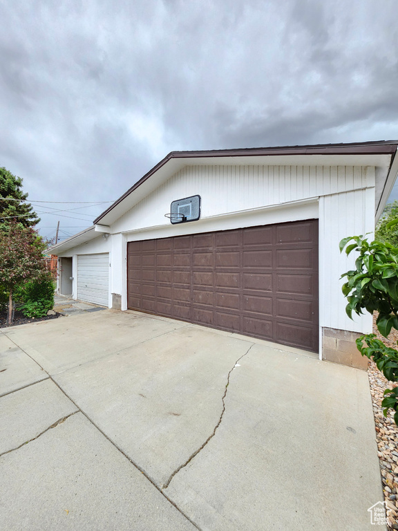 View of front of house with a garage and an outdoor structure