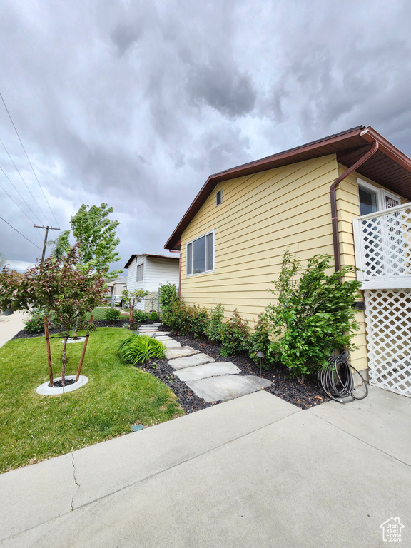 View of side of home with a lawn