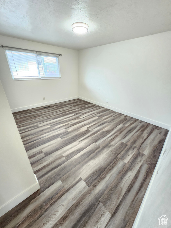 Empty room with baseboards and wood finished floors