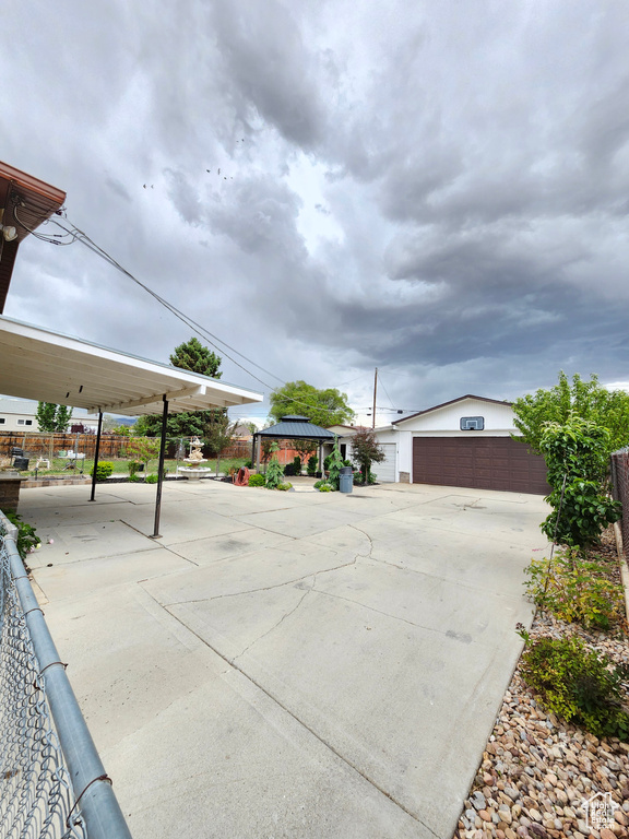 View of patio featuring a gazebo, an outdoor structure, and a detached garage