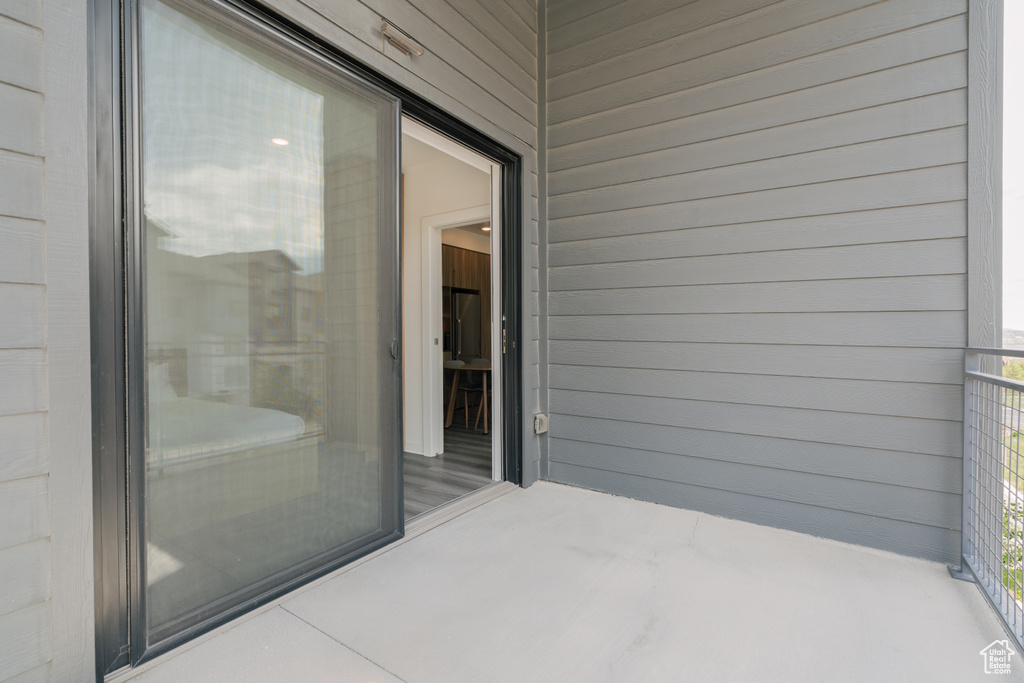 View of patio with a balcony