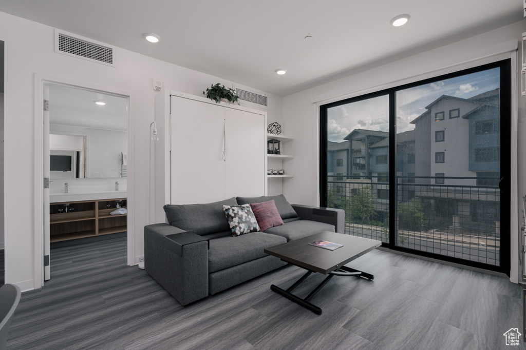 Living room featuring wood finished floors and recessed lighting