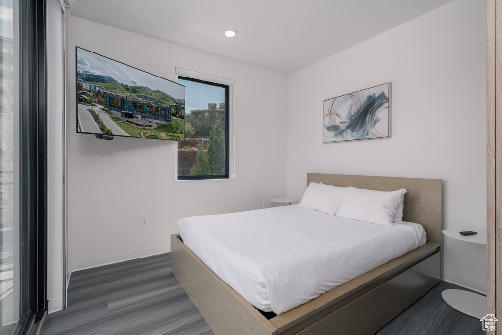 Bedroom with wood finished floors, baseboards, and recessed lighting