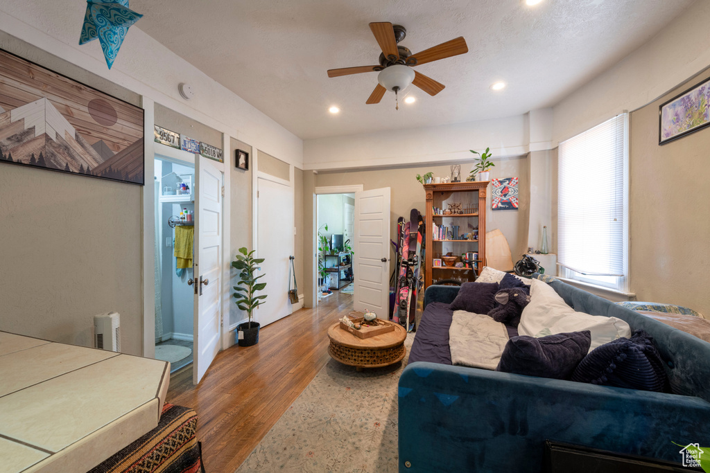 Living room with ceiling fan, recessed lighting, and wood finished floors