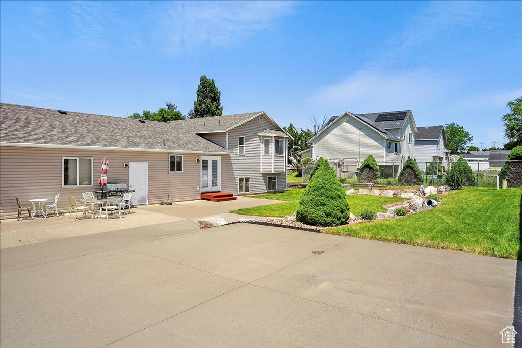 Rear view of house with a patio area and a residential view