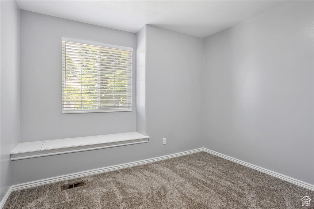 Unfurnished room with carpet flooring and baseboards