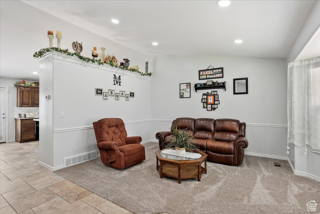 Living room with recessed lighting, vaulted ceiling, and baseboards