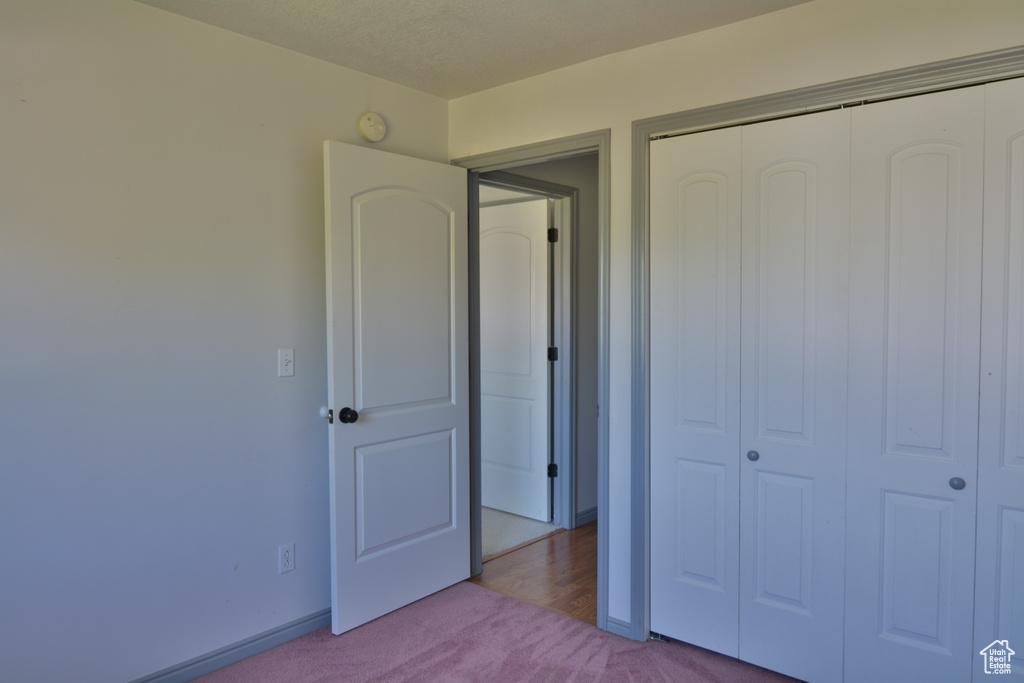 Unfurnished bedroom featuring carpet floors and a closet
