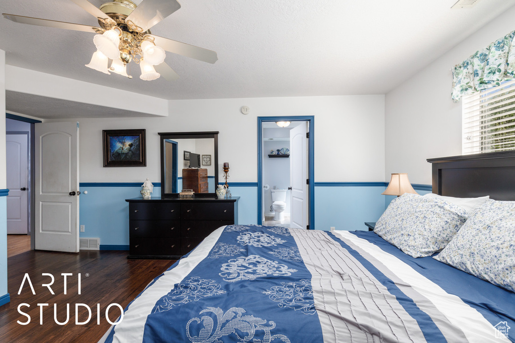 Bedroom with wood finished floors, ceiling fan, and ensuite bath