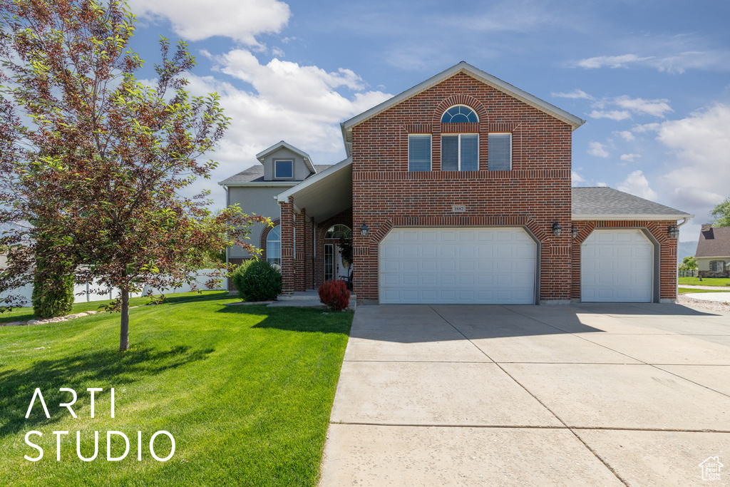 Traditional home featuring brick siding, concrete driveway, a front lawn, an attached garage, and roof with shingles