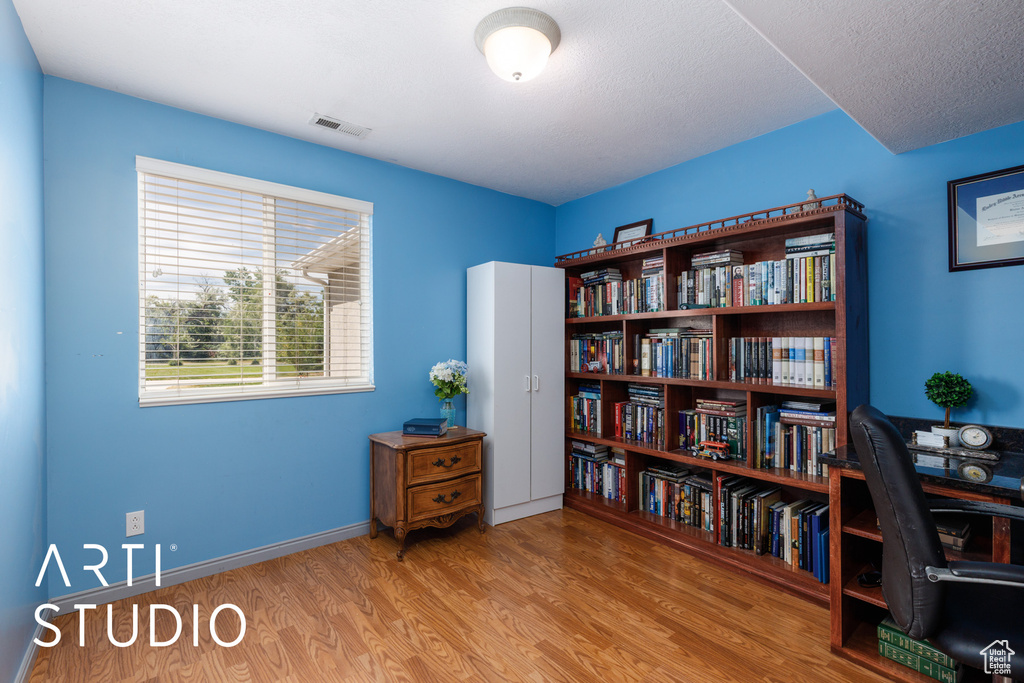 Office space featuring wood finished floors and baseboards