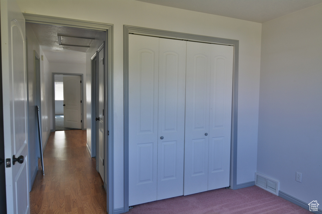 Corridor with baseboards and dark wood-style floors