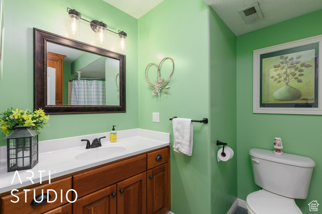 Full bath with toilet and vanity