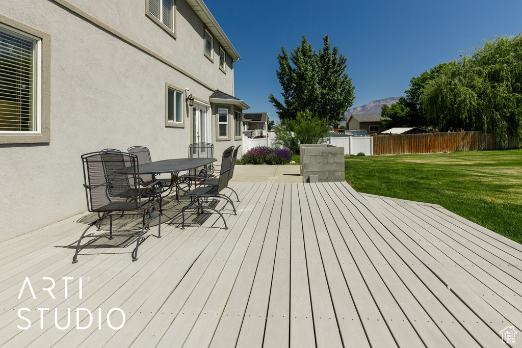 Wooden terrace with outdoor dining area and a mountain view