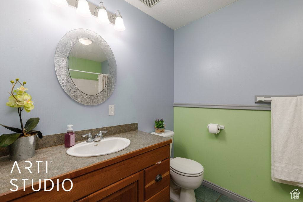 Full bathroom with vanity, toilet, tile patterned flooring, and a shower with shower curtain