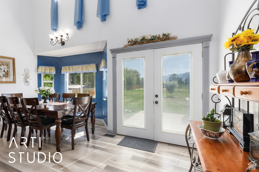Dining room featuring french doors and a high ceiling