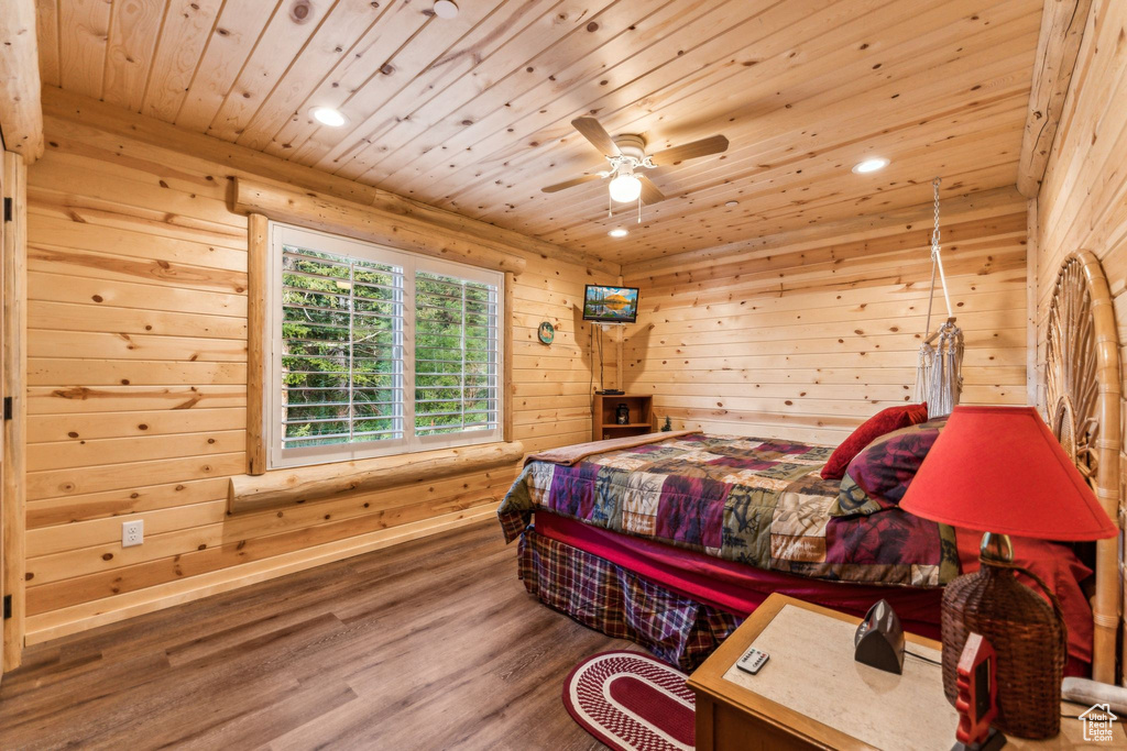 Bedroom with wooden ceiling, wood finished floors, recessed lighting, wood walls, and a ceiling fan