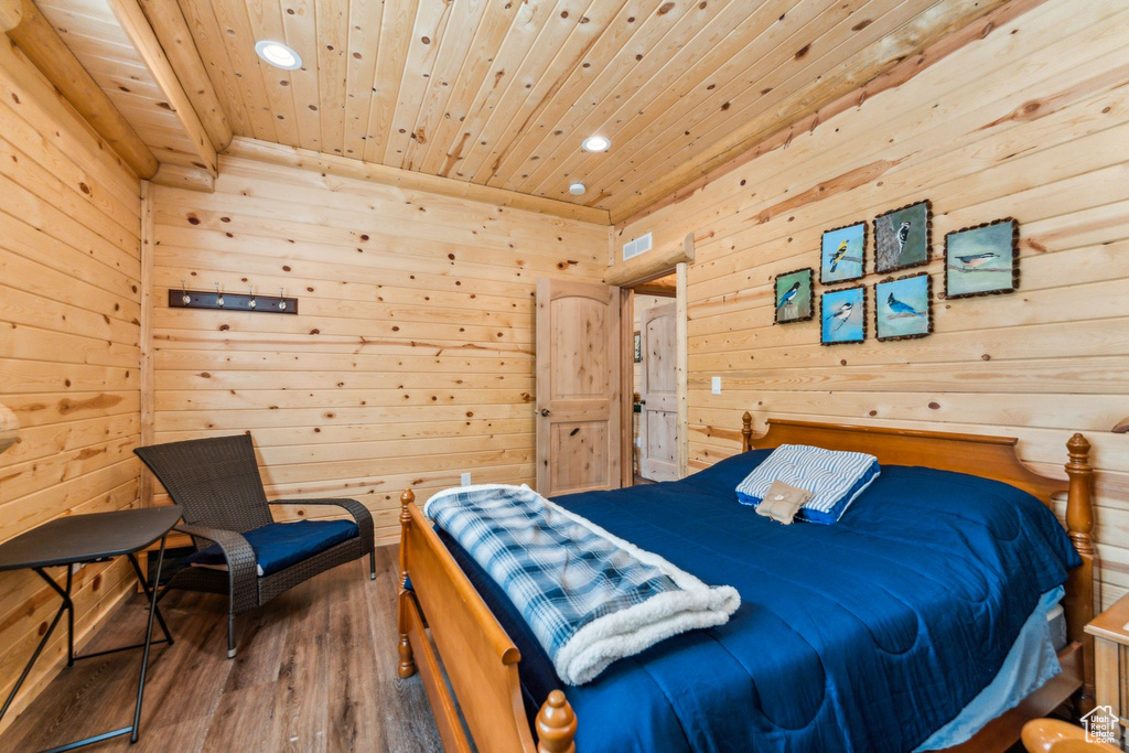 Bedroom featuring wood ceiling, recessed lighting, wooden walls, and wood finished floors