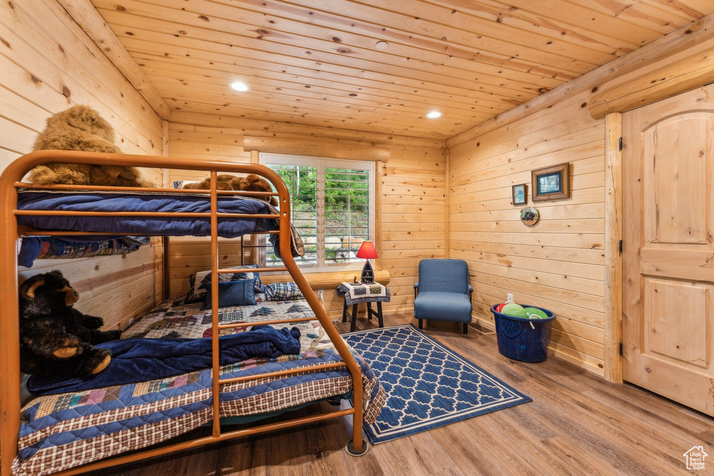 Bedroom featuring wood ceiling, wood finished floors, recessed lighting, and wooden walls