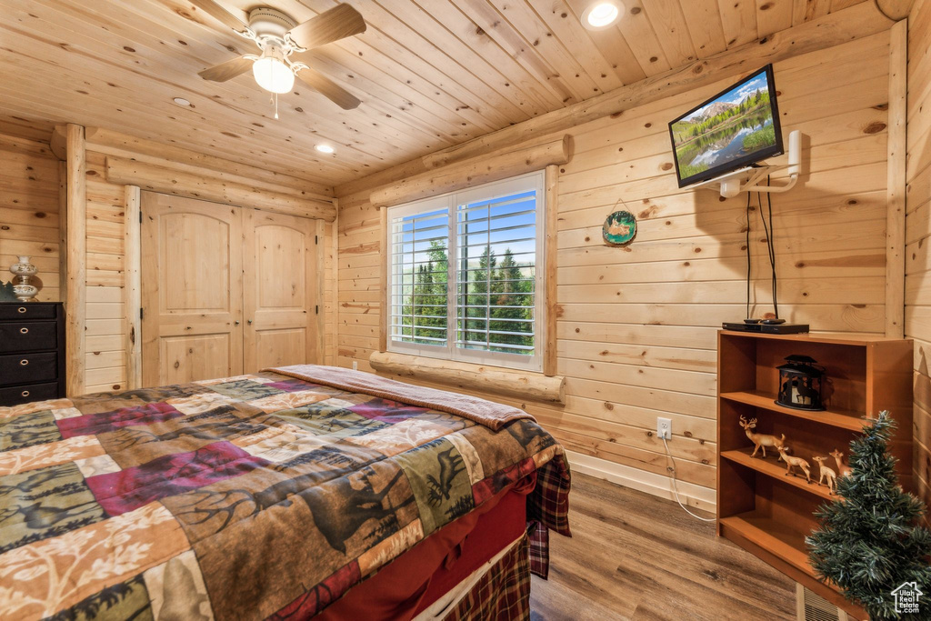 Bedroom with wood ceiling, wood finished floors, recessed lighting, wood walls, and a ceiling fan