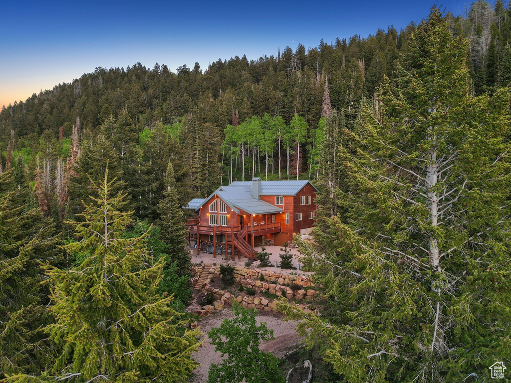 View of subject property featuring a forest