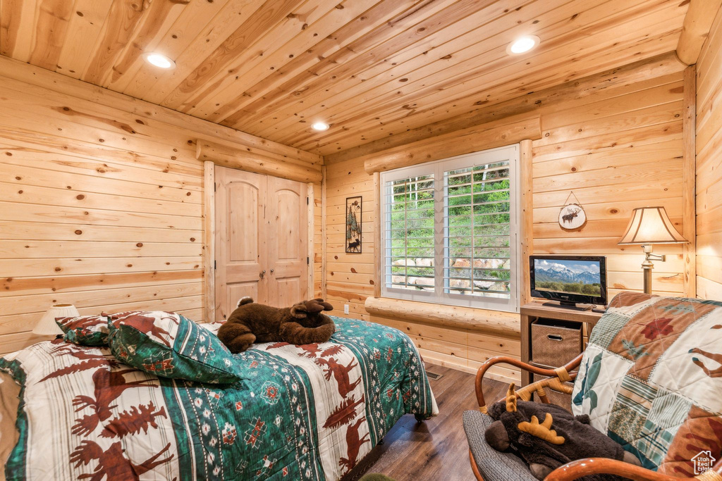 Bedroom with recessed lighting, wood ceiling, wood finished floors, and wood walls