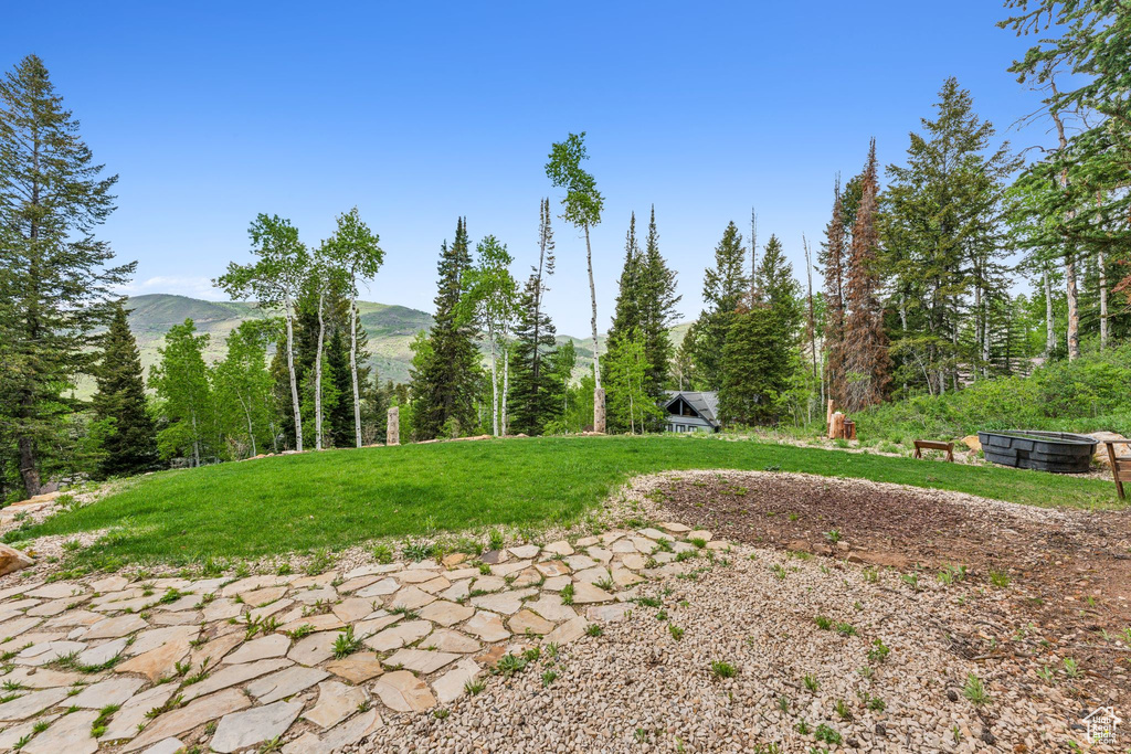 Surrounding community featuring a mountain view and a yard