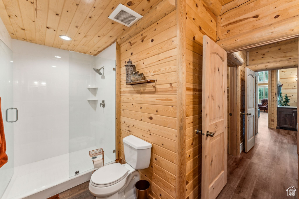 Full bathroom with toilet, a stall shower, wood finished floors, recessed lighting, and wooden ceiling