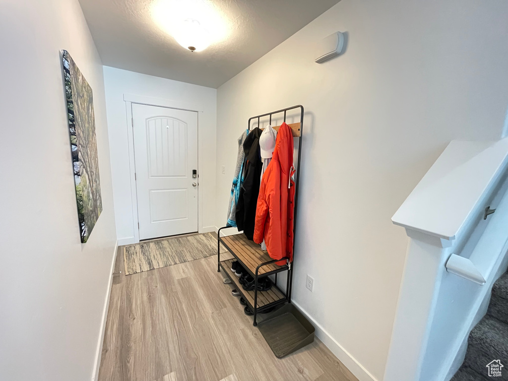 Entryway with wood finished floors and baseboards