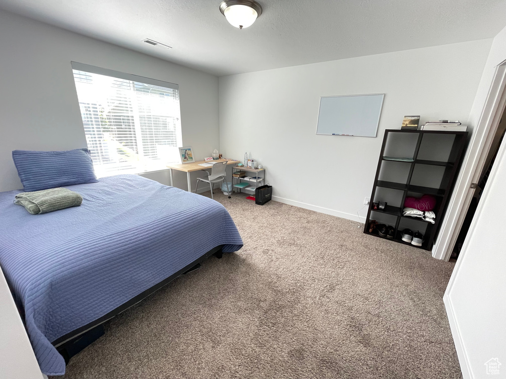 Carpeted bedroom featuring baseboards