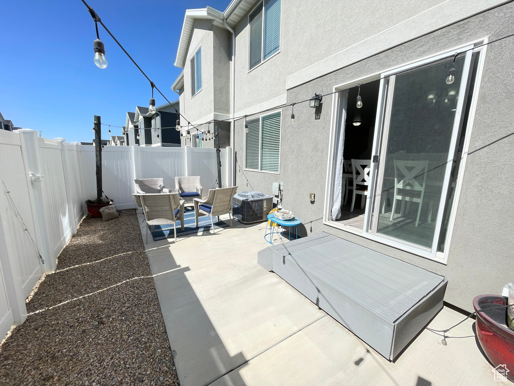 Fenced backyard with a patio and central AC unit