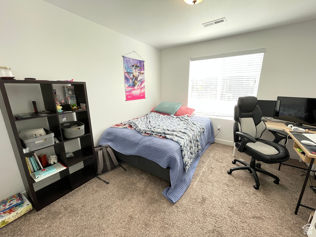 Bedroom with carpet, a desk, and baseboards