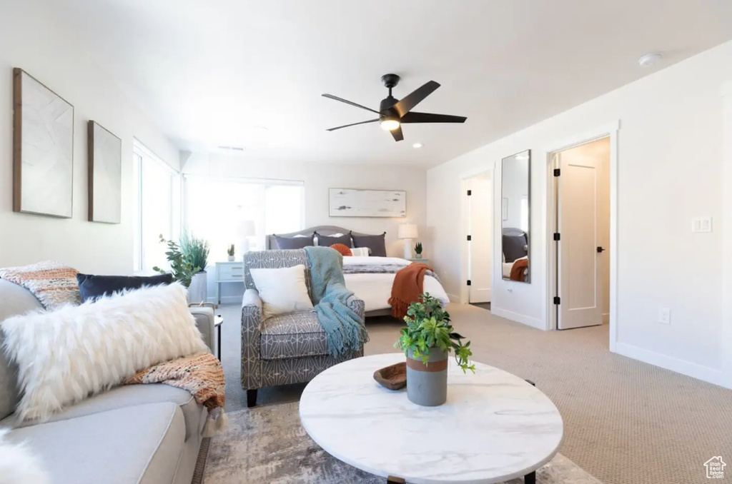 Carpeted bedroom featuring baseboards and ceiling fan