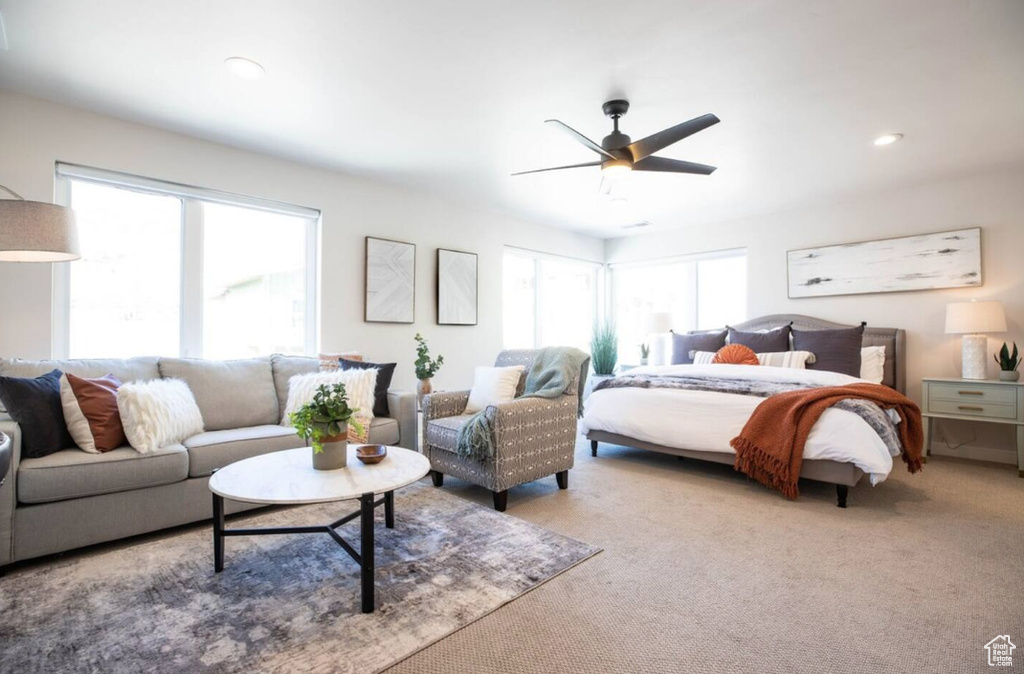 Carpeted bedroom featuring a ceiling fan and recessed lighting