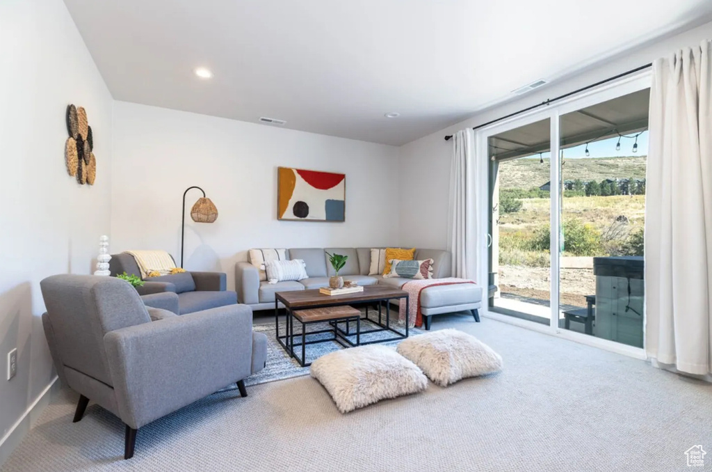 Carpeted living room featuring baseboards and recessed lighting