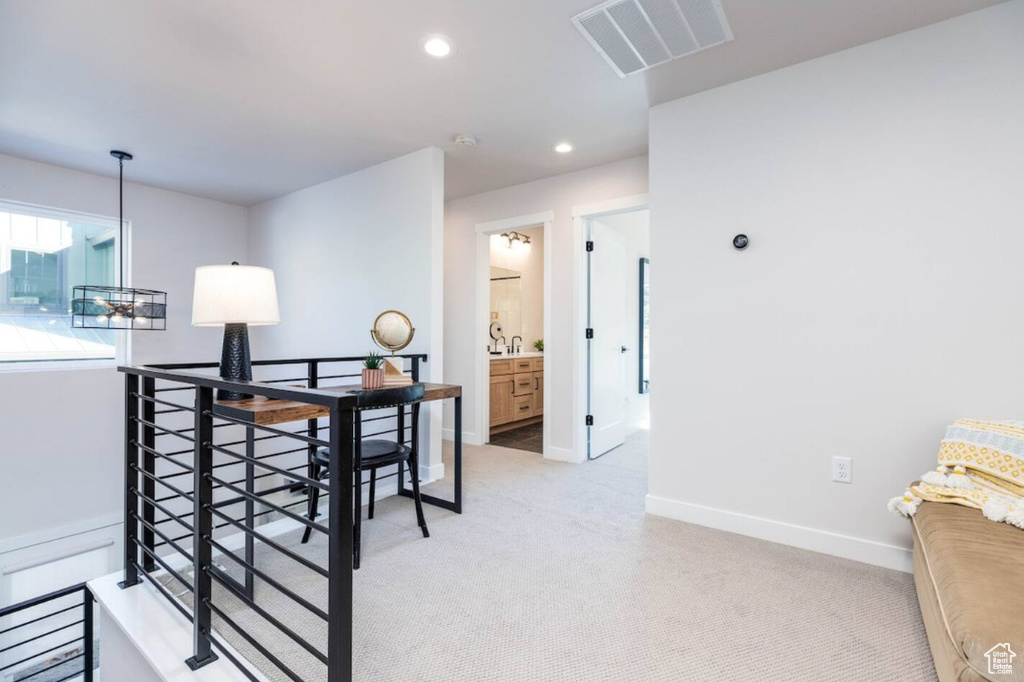 Dining room featuring light colored carpet, baseboards, and recessed lighting
