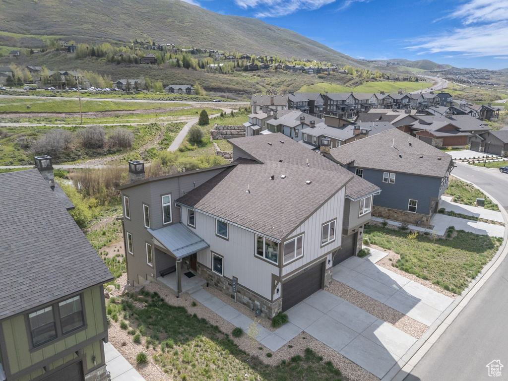 Aerial view of residential area featuring a mountainous background