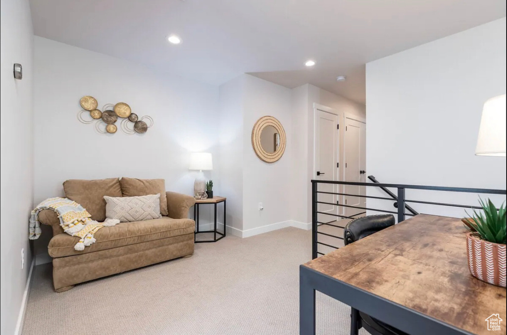 Sitting room with carpet, baseboards, recessed lighting, and an upstairs landing