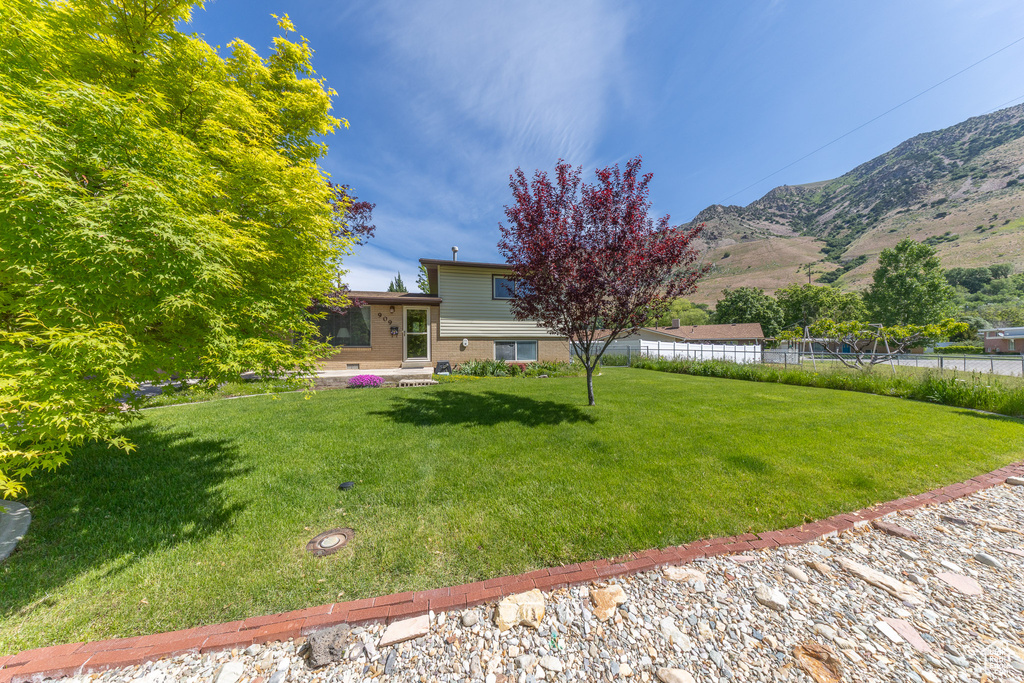 View of yard with a mountain view and entry steps