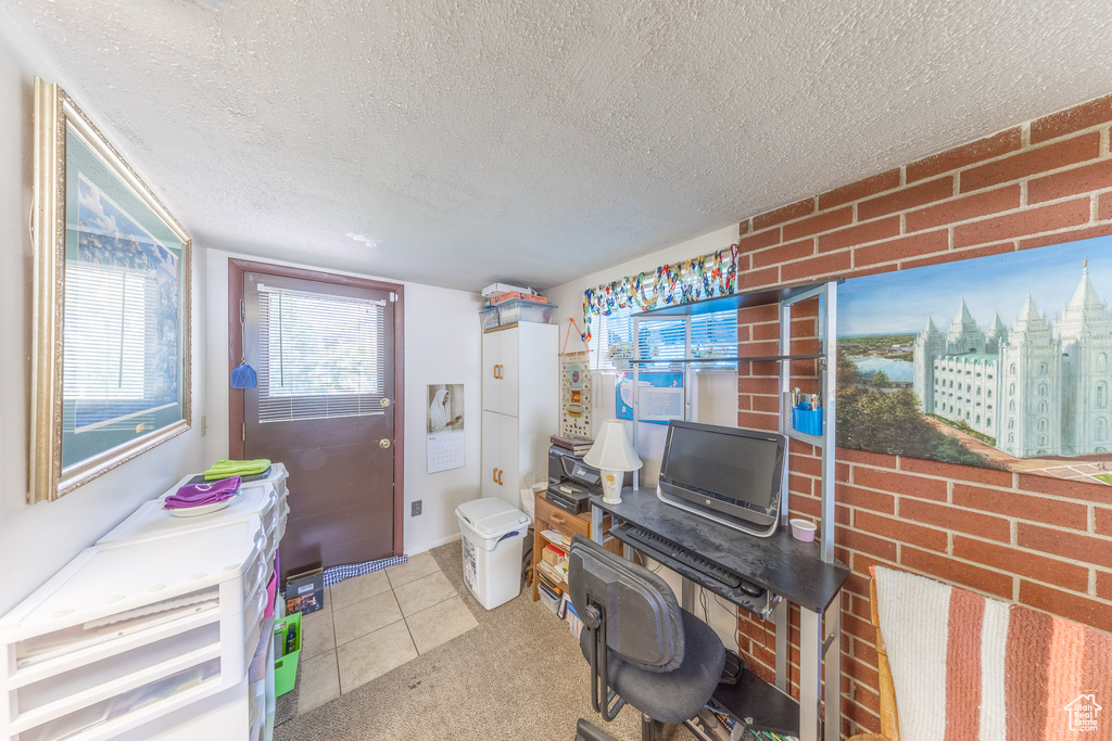 Home office featuring a textured ceiling and tile patterned flooring