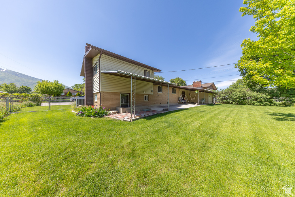 Back of property featuring a patio and brick siding