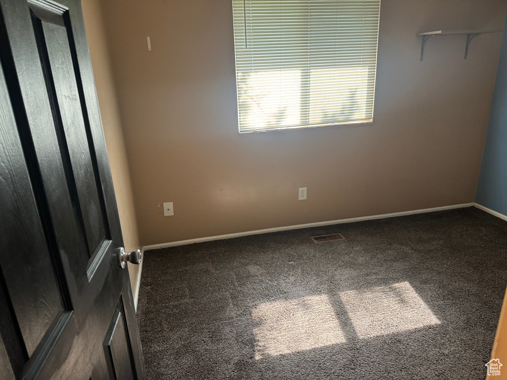 Carpeted spare room with baseboards