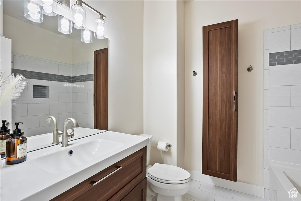 Bathroom with vanity, toilet, tile patterned floors, and  shower combination