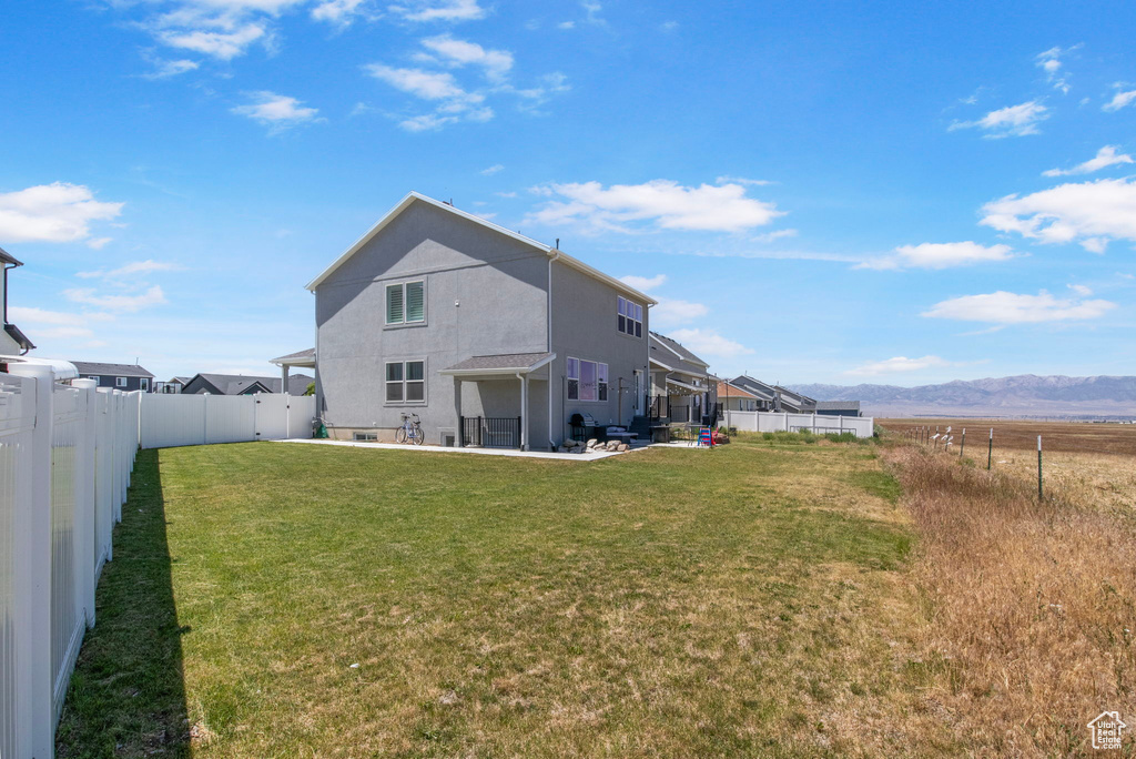 Back of property featuring a patio area, stucco siding, and a mountain view